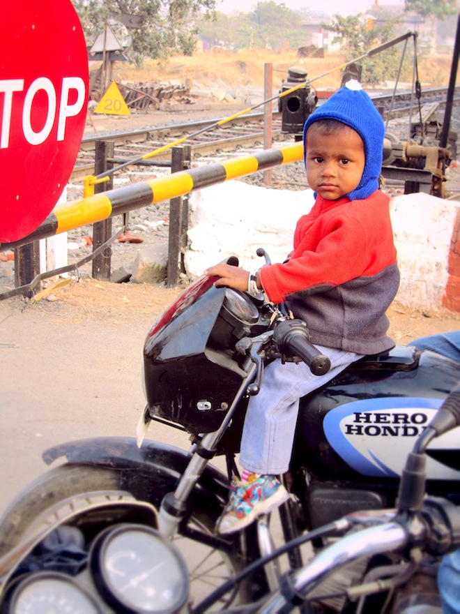 A boy on top of a motorcycle. 