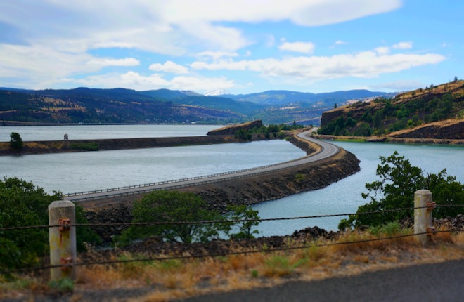 The road subtly zigzags in the Columbia River, from the Washington side. 